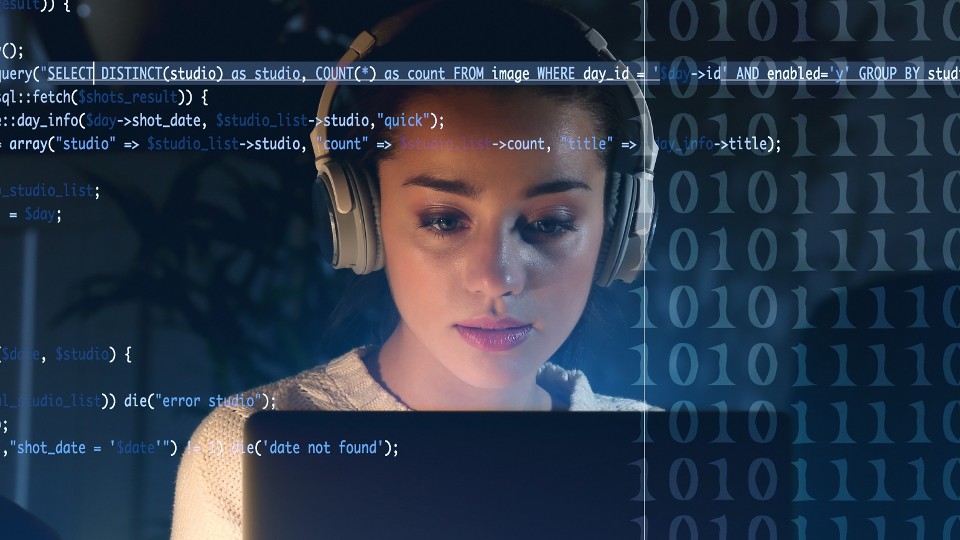 Woman with headphones in front of a laptop with computer code superimposed